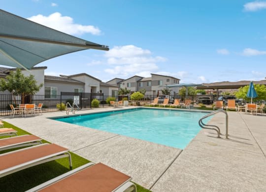 a swimming pool with lounge chairs and buildings in the background at Baseline on 16, Phoenix, Arizona