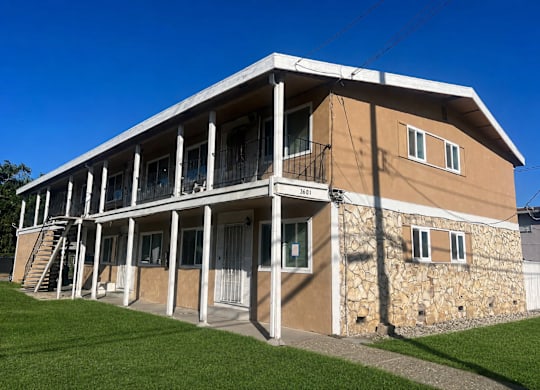 A two-story building with a balcony on the second floor.