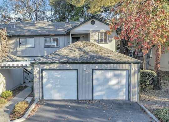 a house with two garage doors in front of it
