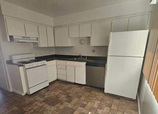 a small kitchen with a stove and a refrigerator