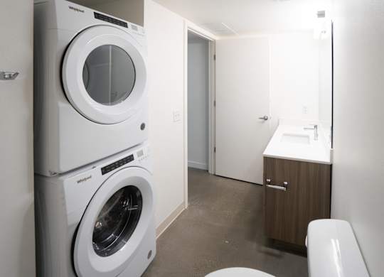 A white washing machine and dryer in a small laundry room.