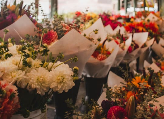 a bunch of bouquets of flowers in a flower shop