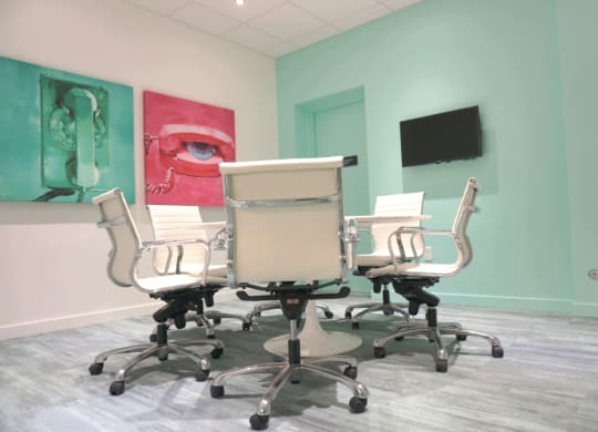 a conference room with a table and chairs