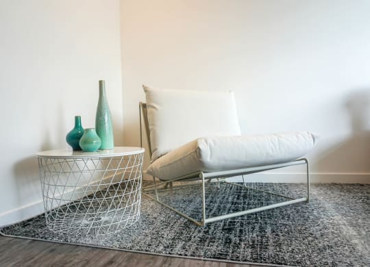 a living room with a chair and a side table
