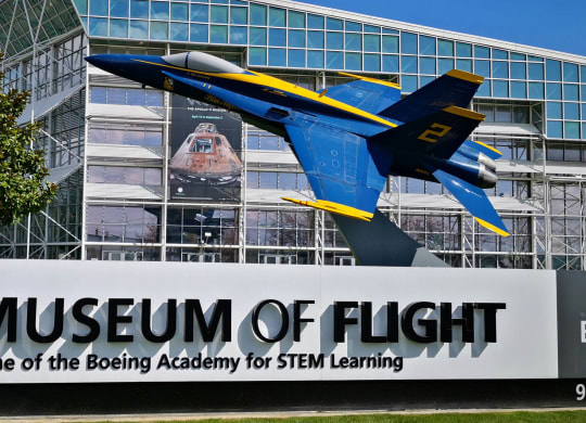 a sign for the museum of flight in front of a building