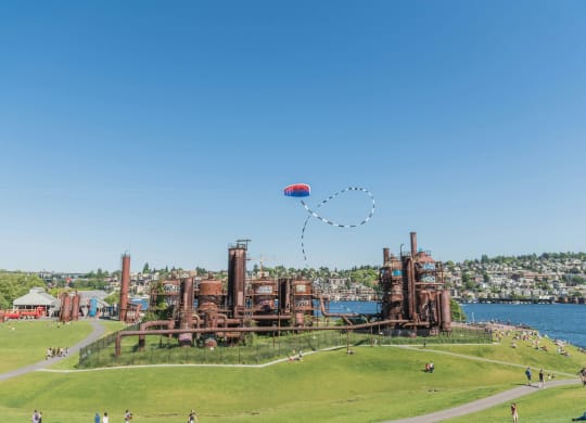 a hot air balloon flying over an old factory