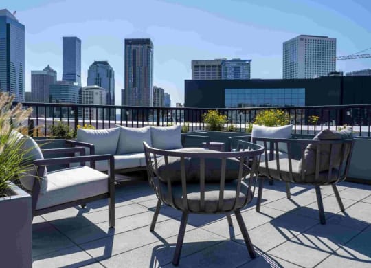 a rooftop patio with a city skyline in the background