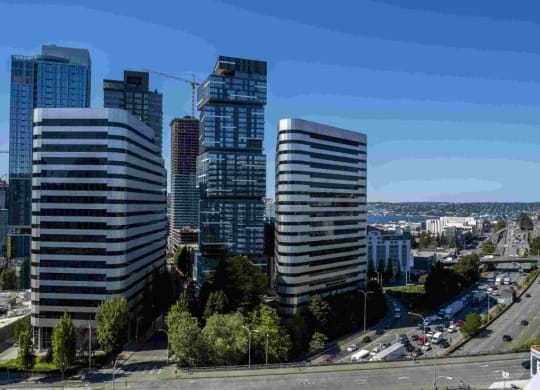 a city skyline with tall buildings and a highway