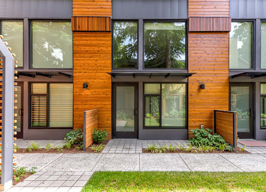 A modern house with a wooden facade and glass windows.