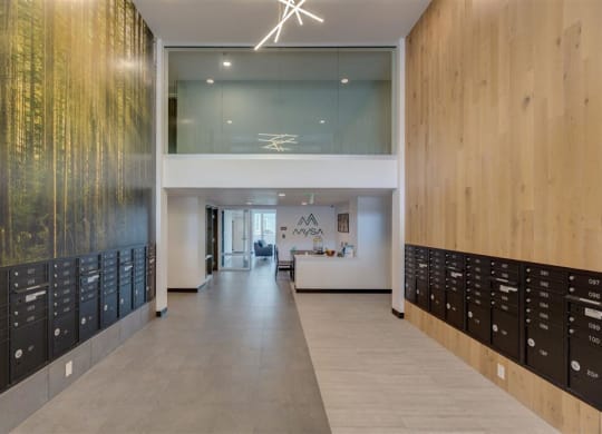 a long hallway with many lockers and a large wall of