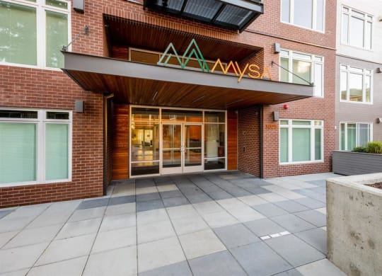 the front entrance of a building with a large glass door