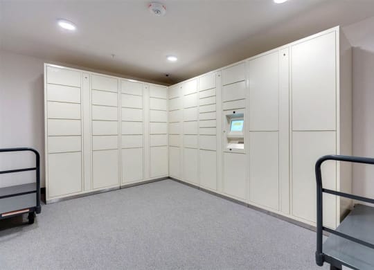 a large closet with white cabinets and a bunk bed