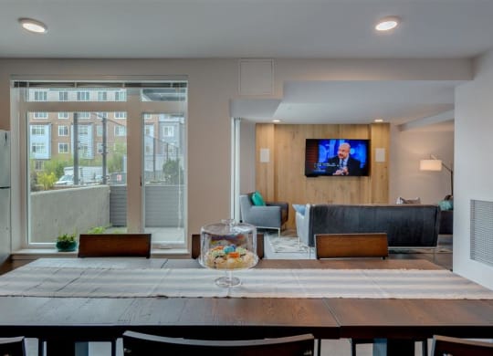 a dining room table and a living room with a tv
