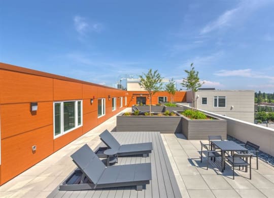 a rooftop terrace with tables and chairs on a roof