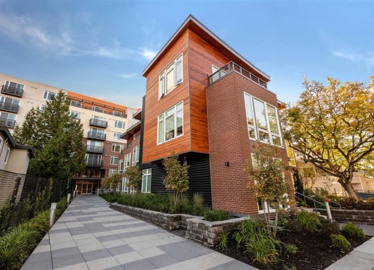 a brick building with a sidewalk in front of it