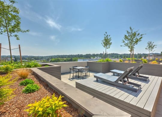 a rooftop terrace with benches and tables