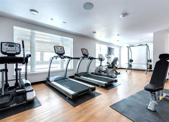 a gym with treadmills and other exercise equipment