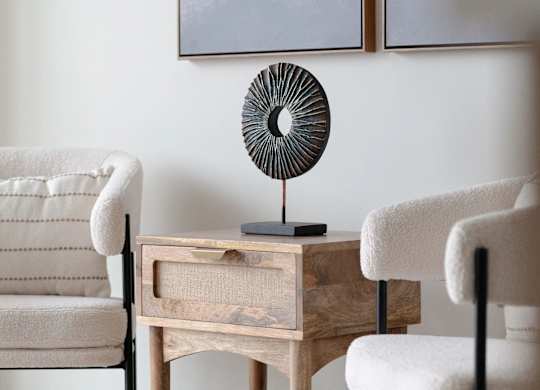 A room with a fan and two chairs.