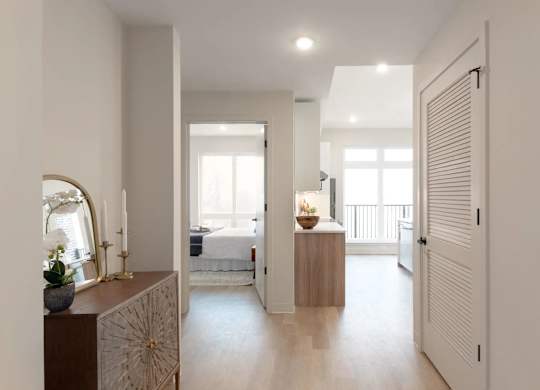 A bedroom with a bed, a dresser, and a mirror.