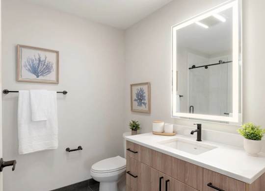 A white towel hangs on a towel rack in a bathroom.