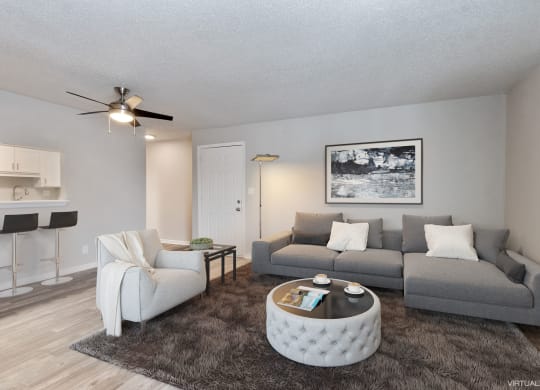an open living room with a couch and a chair  at Eastwood Crossings, Kansas City, MO, 64129