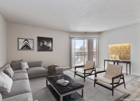 a living room with a couch and chairs and a table  at Eastwood Crossings, Missouri