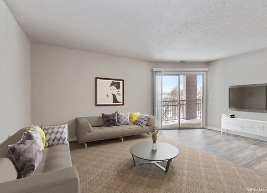 a living room with a couch and a table and a tv  at Eastwood Crossings, Kansas City