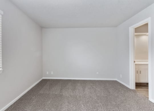 an empty room with white walls and a window at Eastwood Crossings, Missouri