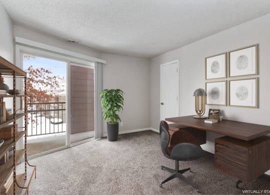 an office with a sliding glass door and a desk with a chair at Eastwood Crossings, Kansas City