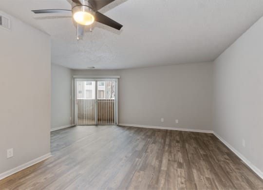 the spacious living room with wood flooring and a ceiling fan at Eastwood Crossings, Kansas City