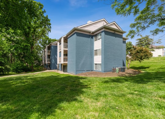 a blue building with grass and trees around it at Eastwood Crossings, Kansas City, MO, 64129