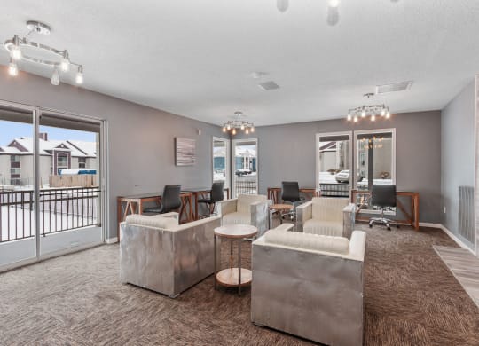 a living room with couches and chairs and a balcony at Eastwood Crossings, Kansas City, MO