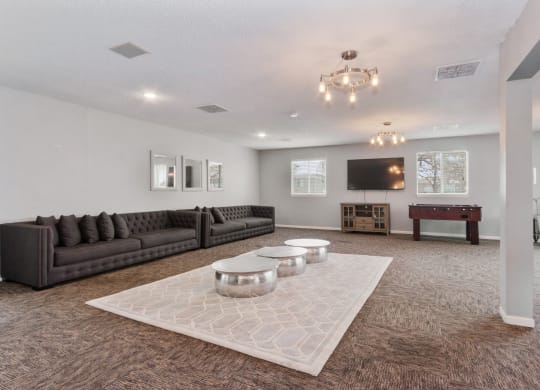 the preserve at ballantyne commons community room with couches and tables at Eastwood Crossings, Kansas City, 64129