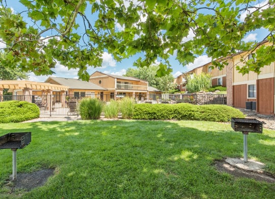 a yard with a grill and a building in the background at Lodge of Overland Park Apartments, Kansas, 66212