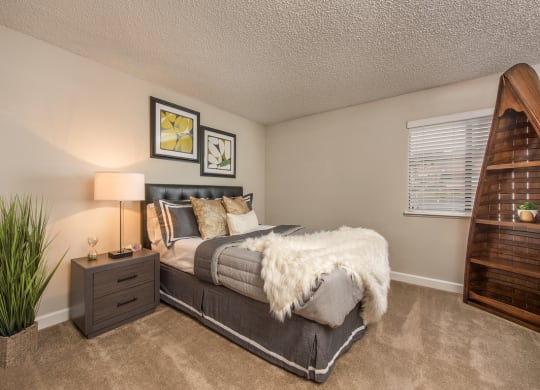a bedroom with a bed and a window at Lodge of Overland Park Apartments, Overland Park , Kansas