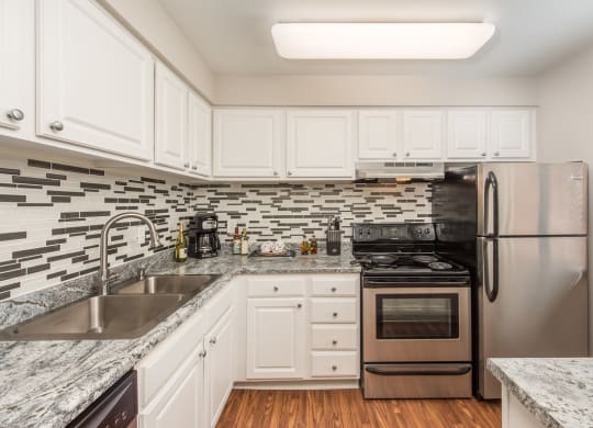 kitchen with white cabinets  at Lodge of Overland Park Apartments, Overland Park