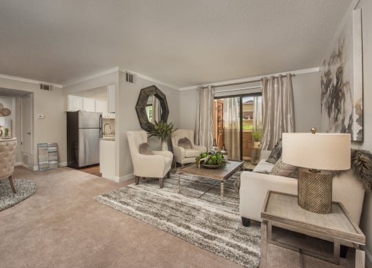 a living room with white furniture and a rug at Lodge of Overland Park Apartments, Overland Park , KS