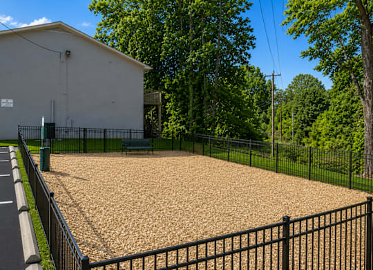 A small building with a parking lot in front of it.