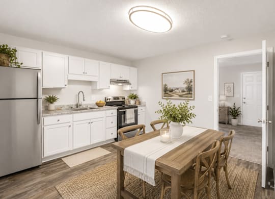 A kitchen with a table and chairs in the middle of the room.