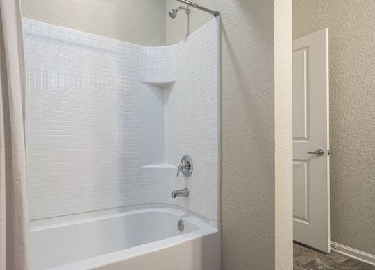 White Bathtub with a Shower at Spring Creek Apartments, Crestview, FL