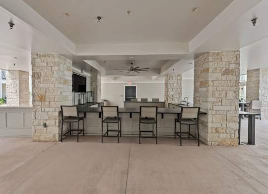 A Spacious Room with a Stone Wall at Citadel at Westpointe Apartments, Texas