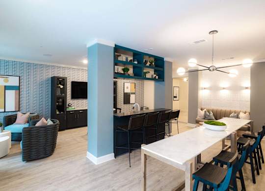 A modern dining room with a white table and chairs at Hudson at Renaissance Apartments, Wilmington, NC 28405