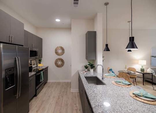 A modern kitchen with a stainless steel refrigerator at Hudson at Renaissance Apartments, Wilmington