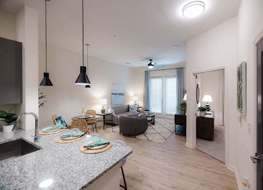 A modern kitchen with granite countertops at Hudson at Renaissance Apartments, Wilmington 28405