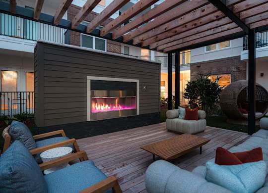A patio with a fireplace at Hudson at Renaissance Apartments, North Carolina 28405