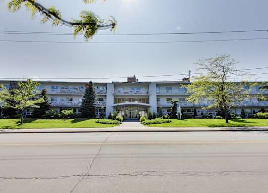a large white building with a street in front of it