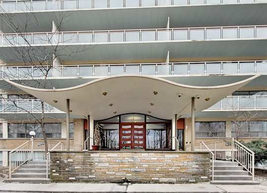 A modern building with a curved overhang in front.