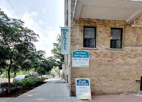 a brick building with a park terrace sign on the side of it