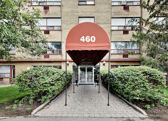 the building where the hotel is located has a red awning over the entrance