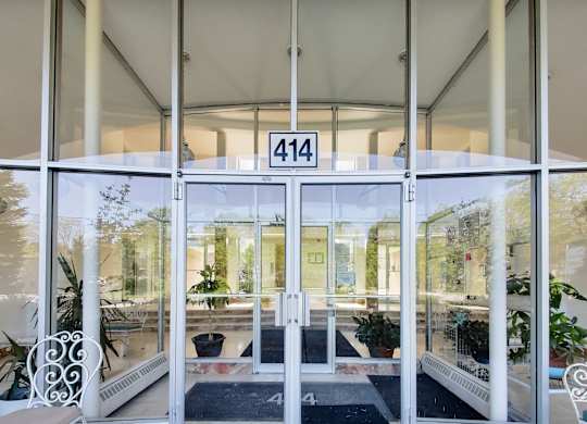 the entrance of a building with glass doors and windows